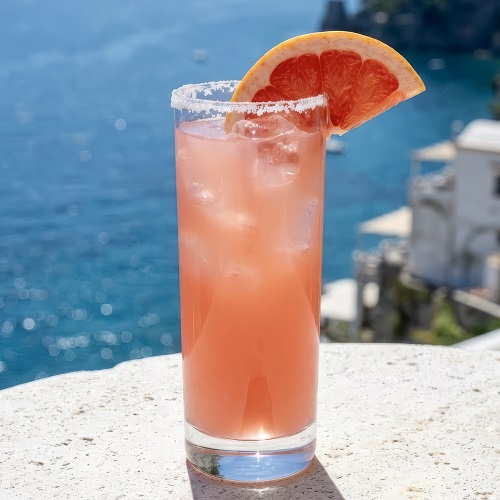 Salty Dog cocktail with salted rim, grapefruit slice, and vodka served over ice in a rocks glass.